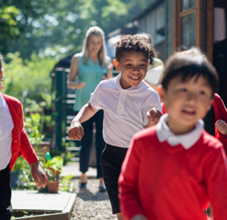 Happy school children in outdoor setting